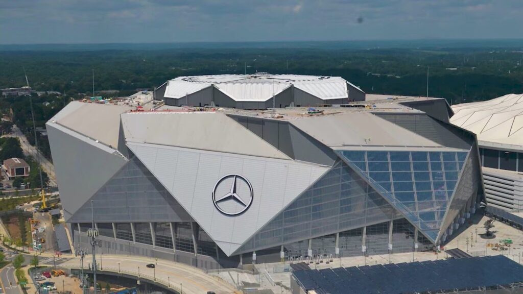 Mercedes Benz Stadium in Atlanta, Georgia, with its distinctive angular exterior roof design and large Mercedes Benz logo on the stadium façade.